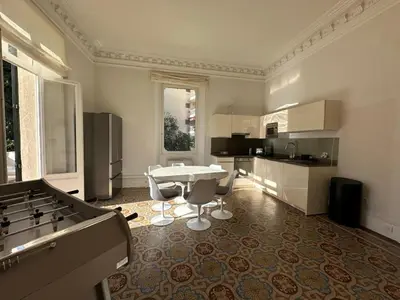 a large kitchen with a table and chairs in it at C025 Villa Toscane Bel Appartement Bourgeois in Cannes