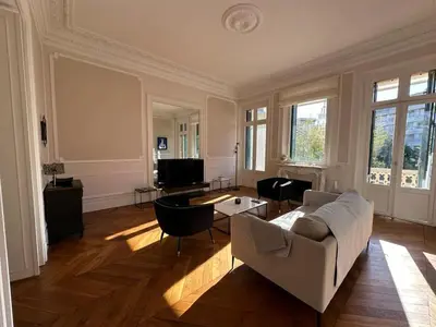 a living room with a couch and a table at C025 Villa Toscane Bel Appartement Bourgeois in Cannes