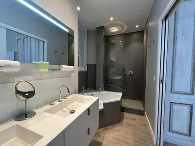 a bathroom with two sinks and a tub and a shower at C025 Villa Toscane Bel Appartement Bourgeois in Cannes