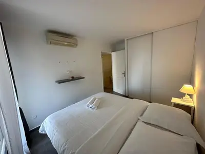 a bedroom with a large white bed with a white phone on it at C058 Bel appartement spacieux terrasse Centre in Cannes