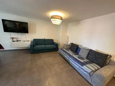 a living room with a couch and a tv at C058 Bel appartement spacieux terrasse Centre in Cannes