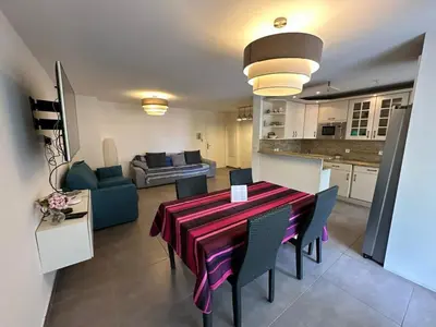 a dining room and kitchen with a table and chairs at C058 Bel appartement spacieux terrasse Centre in Cannes