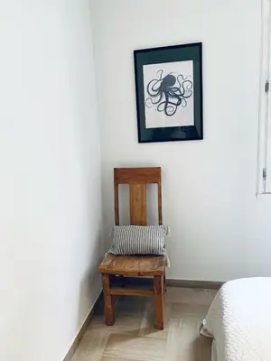 a room with a chair and a picture on the wall at La Maison By Simone T4 in Cannes