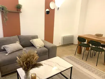 a living room with a couch and a table at La Maison By Simone T4 in Cannes