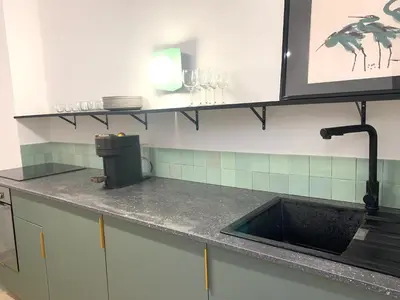 a kitchen with a sink and a counter top at La Maison By Simone T4 in Cannes