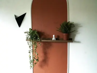 a wall with a shelf with plants on it at La Maison By Simone T4 in Cannes