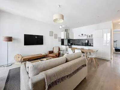 a living room with a couch and a table at 64m2 face Majestic - 50m palais & plages in Cannes
