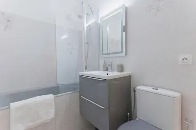 a bathroom with a toilet and a sink and a tub at Amandier du Moure Rouge in Cannes
