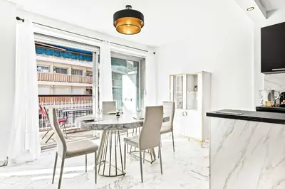 a kitchen and dining room with a table and chairs at SUNBLUE - Accommodation Center Cannes & port in Cannes