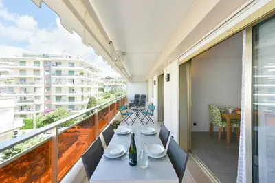 a balcony with a table and chairs on it at Renovated 1Br apartment terrace walk to beach in Cannes