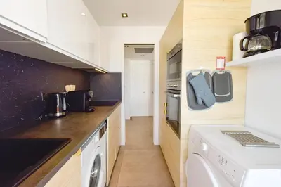 a kitchen with a washer and dryer on the counter at Renovated 1Br apartment terrace walk to beach in Cannes