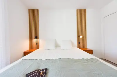 a bedroom with a bed with two pillows at Renovated 1Br apartment terrace walk to beach in Cannes