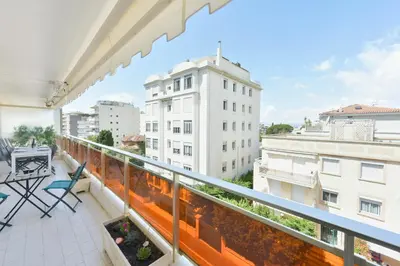 a balcony with a view of a building at Renovated 1Br apartment terrace walk to beach in Cannes