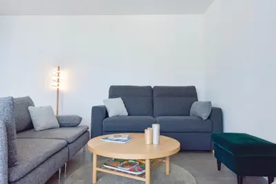 a living room with a couch and a table at Renovated 1Br apartment terrace walk to beach in Cannes