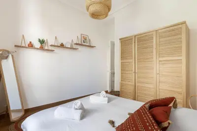 a bedroom with a white bed with towels on it at Le Louis- Superbe logement à 5mins des plages, proche Palais in Cannes