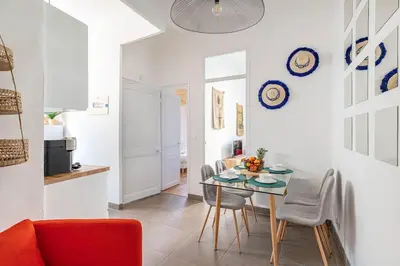 a kitchen and dining room with a table and chairs at Le Louis- Superbe logement à 5mins des plages, proche Palais in Cannes