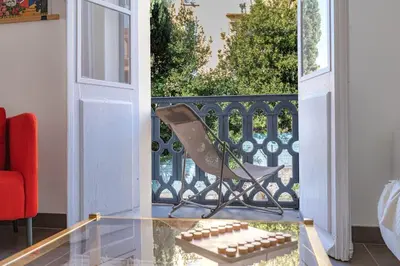 a chair sitting on a glass table on a balcony at Le Louis- Superbe logement à 5mins des plages, proche Palais in Cannes