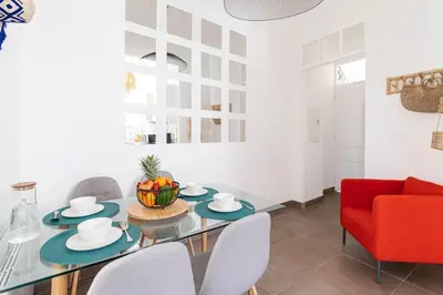 a dining room with a glass table and a red chair at Le Louis- Superbe logement à 5mins des plages, proche Palais in Cannes
