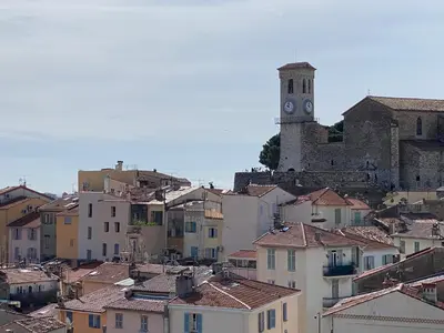 a city with a clock tower in the background at Cannes centre Lou Souquetan in Cannes