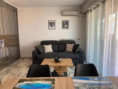 a living room with a couch and a table at Cannes centre Lou Souquetan in Cannes