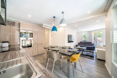 a kitchen and living room with a table and chairs at Centre ville Croisette in Cannes