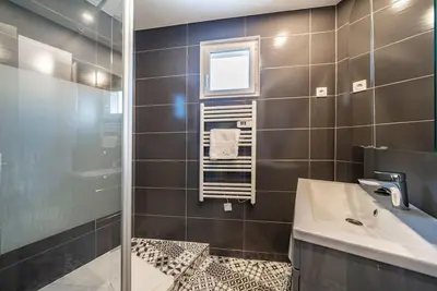a bathroom with a sink and a shower and a mirror at Centre ville Croisette in Cannes