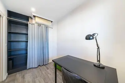 a desk with a lamp on it in a room at Centre ville Croisette in Cannes