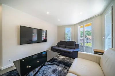 a living room with a couch and a flat screen tv at Centre ville Croisette in Cannes