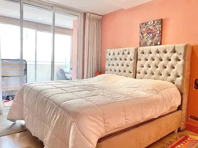 a bedroom with a large bed and a large window at Grand Hotel 2 chambres 2 sdb - GH in Cannes