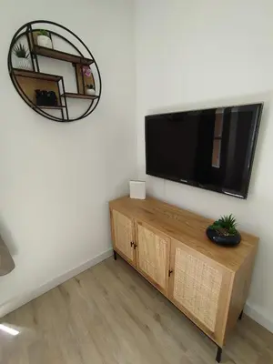 a living room with a flat screen tv on a wall at Grand studio avec terrasse in Cannes