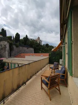 a balcony with two chairs and a table on a building at Grand studio avec terrasse in Cannes