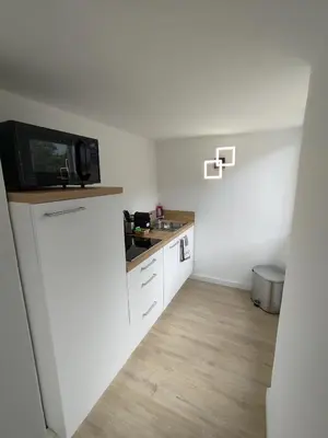 a small kitchen with a sink and a microwave at Grand studio avec terrasse in Cannes