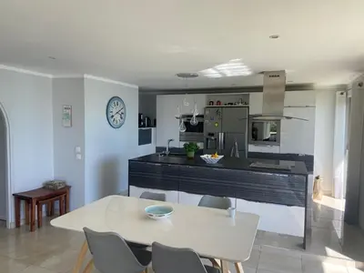 a kitchen and dining room with a table and chairs at Appartement vue panoramique sur Cannes, 100M2 3P in Cannes