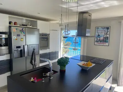 a kitchen with a black counter top and a sink at Appartement vue panoramique sur Cannes, 100M2 3P in Cannes