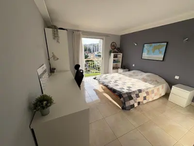 a bedroom with a bed and a window at Appartement vue panoramique sur Cannes, 100M2 3P in Cannes