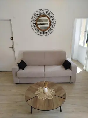 a living room with a couch and a table at Studio mezzanine in Cannes