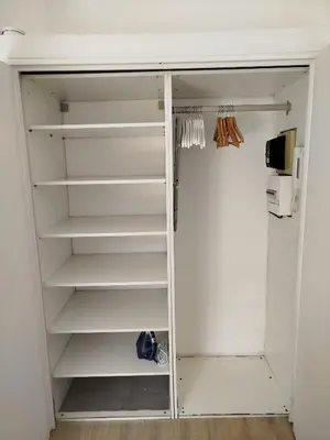 a white closet with white shelves and a refrigerator at Studio mezzanine in Cannes