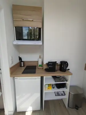 a small desk in a room with a microwave at Studio mezzanine in Cannes