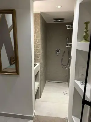 a bathroom with a shower and a sink and a mirror at Résidence Cannes Plage Business Saisonnier in Cannes