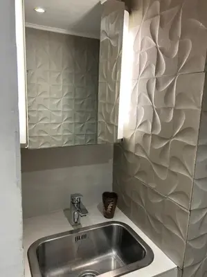 a kitchen sink with a mirror and a counter top at Résidence Cannes Plage Business Saisonnier in Cannes