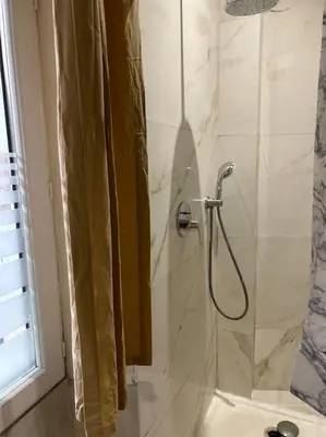a shower in a bathroom with a shower curtain at Résidence Cannes Plage Business Saisonnier in Cannes