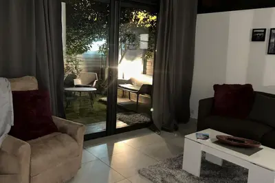 a living room with a couch and a table at Résidence Cannes Plage Business Saisonnier in Cannes