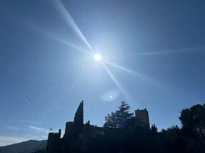 a sun setting over a castle in the sky at Résidence Cannes Plage Business Saisonnier in Cannes