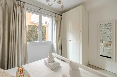 a white room with a window and a bed at Cosy 2-Bedroom apartment - close to Martinez Hotel in Cannes
