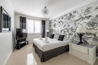 a bedroom with a large bed with a flower mural at Cosy 2-Bedroom apartment - close to Martinez Hotel in Cannes