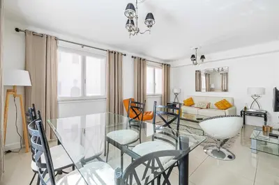 a dining room with a glass table and chairs at Cosy 2-Bedroom apartment - close to Martinez Hotel in Cannes