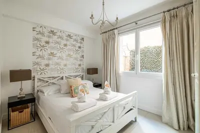 a bedroom with a white bed with towels on it at Cosy 2-Bedroom apartment - close to Martinez Hotel in Cannes