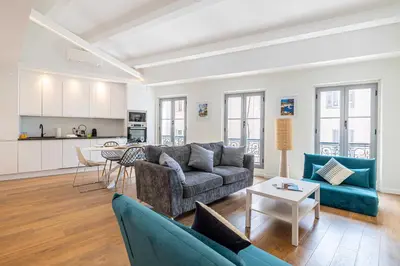 a living room with a couch and a table at Charming apartment - Near the Old Port and Suquet in Cannes