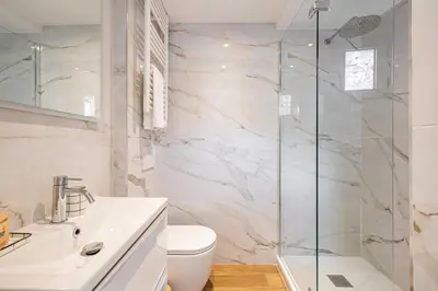 a white bathroom with a shower and a toilet at Charming apartment - Near the Old Port and Suquet in Cannes