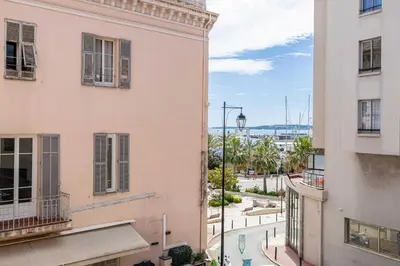 a view of a street between two buildings at Charming apartment - Near the Old Port and Suquet in Cannes